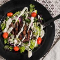 Black 'N Bleu Salad · Six ounces flat iron steak grilled to perfection, chopped romaine and field greens, red onio...