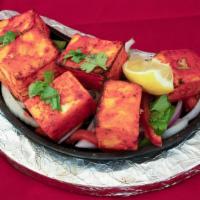 Anchaari Paneer Tikka · Home made paneer cheese marinated in our special Indian pickle sauce, grilled to perfection.