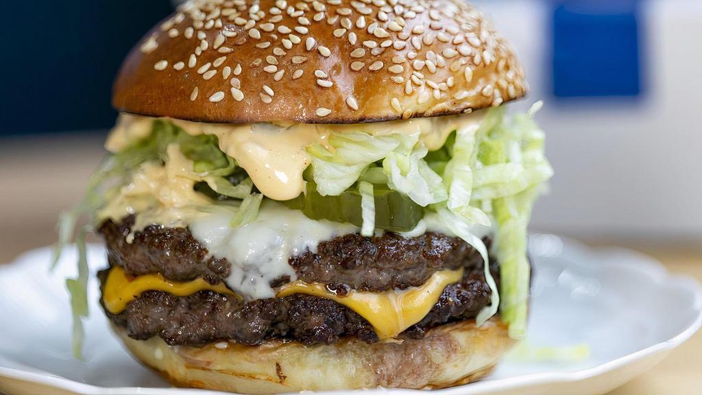 The Double Decker Burger · American cheese, pickles, onions, shredded lettuce, and special sauce.
