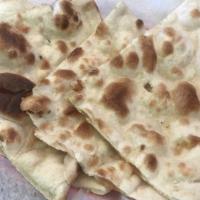 Garlic Naan · Flat bread baked in a tandoor and topped with fresh garlic and cilantro.