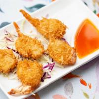 Coconut Shrimp (5) · Jumbo marinated shrimp, coated with coconut flakes, fried until golden brown, served with ou...