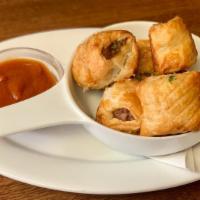 Mini Sausage Rolls · our house made english banger meat wrapped in
crispy puff pastry. served with curry ketchup.