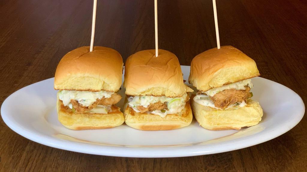 Crispy Chicken Sliders · battered & fried chicken tenders topped with house
made slaw & pickle slices. served on a potato roll with
creamy dill sauce. [3 sliders]