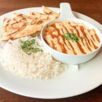 Manta’S Butter Chicken · curried tomato cream sauce w/cashew butter topped w/ chopped cilantro and spiced yogurt. Ser...