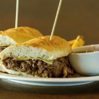 French Dip · Slow roasted beef, shaved thin on a toasted baguette with sautéed mushrooms, onions, horsera...