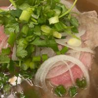 Dac Biet · Three size bowls of Vietnamese beef noodle soup with rare steak, well done frank, tendon and...
