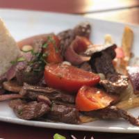 Lomo Saltado · Gluten-free. Tender steak strips sautéed with onions and tomatoes in a red wine sauce. Serve...