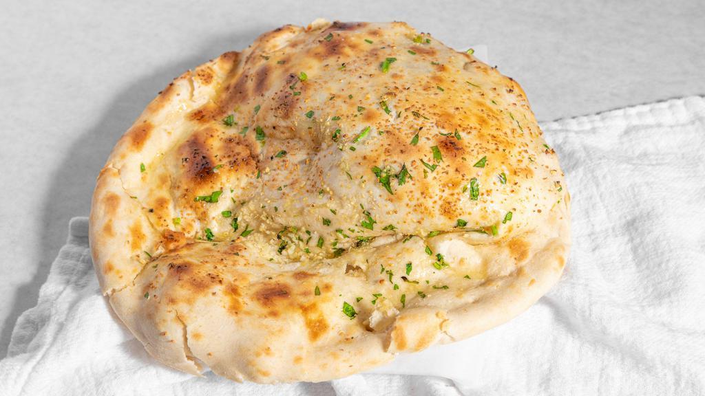 Garlic Naan · Bread stuffed with fresh minced garlic and herbs, baked in tandoor clay oven.