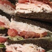 Turkey Club · TRIPLE LAYERED SANDWICH WITH LETTUCE, TOMATO, & TURKEY BACON. SERVED ON YOUR CHOICE TOAST.