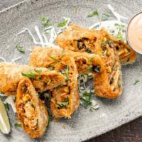 Chipotle Chicken Roll Ups · chipotle chicken, black beans, corn, onions, pepper jack cheese, jalapeño crema.