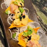 Poke Chips · Chopped wild tuna and avocado, topped with homemade spicy mayo, black caviar, scallions and ...