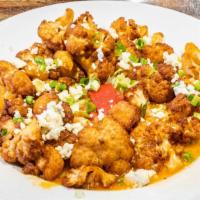 Buffalo Cauliflower · Tossed in house mild sauce & topped with blue cheese crumbles & scallions