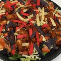 California Bbq Chicken Salad · Crispy chicken smothered in BBQ sauce, cubed tomatoes, black beans, and shredded cheddar che...