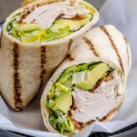 Turkey Avocado Wrap · Our fresh cooked turkey, avocado, crispy bacon, lettuce, and ranch dressing. Served with cho...