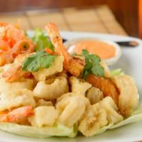 Fried Calamari And Shrimp · Deep fried marinated Monterey squid, whole shrimp with pepper and Thai herbs. Served with sw...