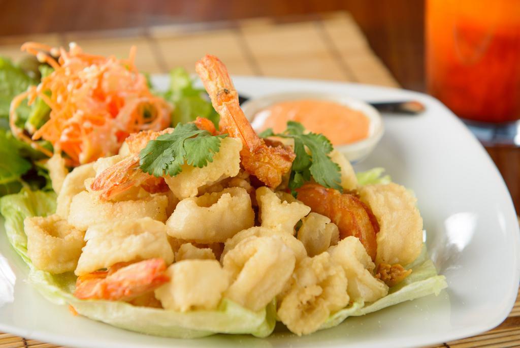 Fried Calamari And Shrimp · Deep fried marinated Monterey squid, whole shrimp with pepper and Thai herbs. Served with sweet and sour sauce.