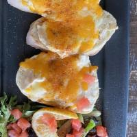 Crab Toast · Sweet Maryland crab blended with cheeses and spices on grilled french baguette with melted c...