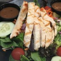 Spinach Salad · Grilled chicken over baby spinach with cherry tomatoes, shredded carrot, crumbled bacon, har...