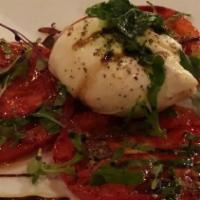 Pomodoro Mozzarella Burrata · Homemade burrata. Served with hothouse tomatoes and basil. Finished with olive oil and fig b...