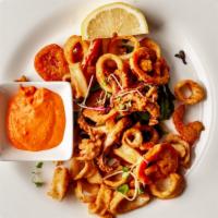 Basile Calamari · Tempura battered calamari, spicy cherry peppers and fried. Served with spicy aioli.