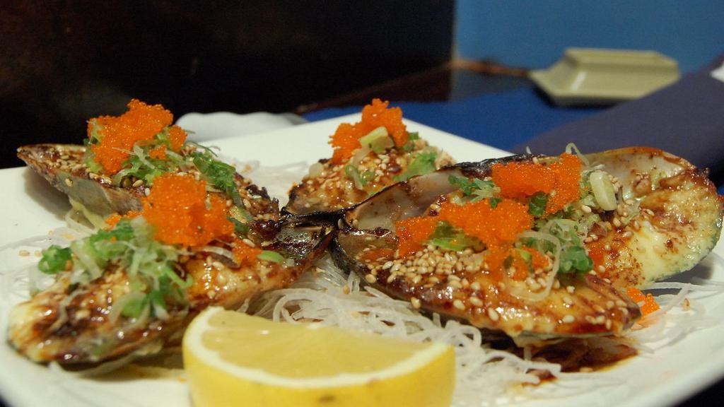 Baked Mussel (4) · Baked mussel with our dynamite sauce. Garnished with tobiko and green onion, eel sauce.