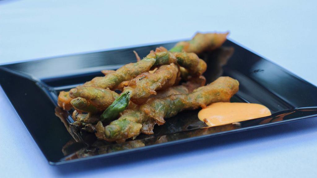 Crispy Green Beans · Deep fried lightly battered Fresh green beans served with spicy mayo dipping sauce.
