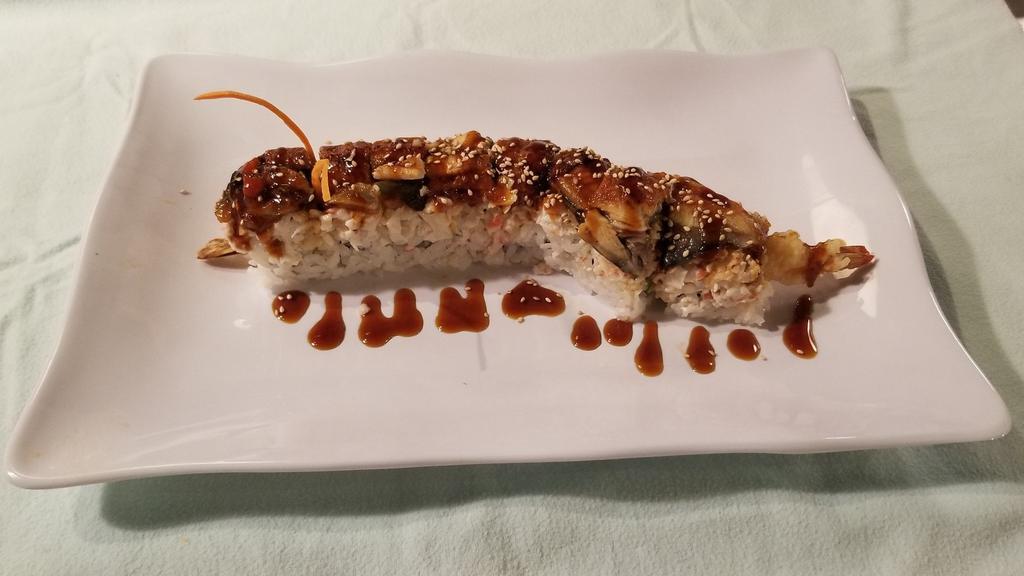 Dragon · Cooked. In: cucumber, avocado, crab meat, out: bbq eel, sesame seed, sauce: sweet glaze.