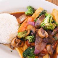 Veggie Saltado · Wok stir-fry vegetables, onions, tomatoes, and french fries, served with white rice