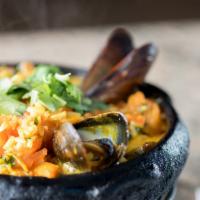 Seafood Rice Casserole · Arroz Com Mariscos. Shrimp, mussels, & squid, tomato, onion, cilantro & coconut milk.