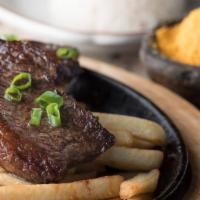 Picanha - Prime Cut Sirloin · Picanha Na Tábua. Served on a cast iron skillet with vinaigrette, french fries, farofa, rice...