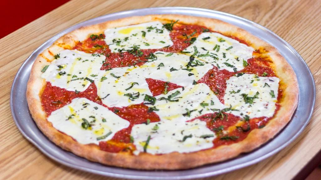 Margherita Pizza · Tomato Sauce, Imported Pomodorini, Sliced Fresh Mozzarella, Fresh Basil & Extra Virgin Olive Oil.