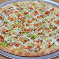 Taco Pizza · Ground beef, lettuce, tomato, a drizzle of buffalo and ranch dressing.