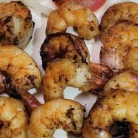 Camarones Asados · Grilled Jumbo shrimp with honey, olive oil, lime juice and service with the house salad, a b...