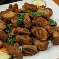 Crispy Pork Ribs · Fried marinated pork ribs with spices.