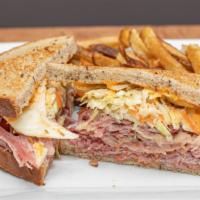 The New Yorker · Corned beef and pastrami with Russian dressing and coleslaw on toasted rye.