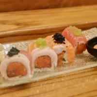 Cha Cha Roll · Spicy crunchy tuna inside, topped with salmon, tuna, white tuna, black tobiko and green tobi...