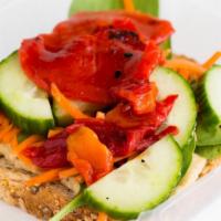 Veggie Hummus Toast · Hummus topped with spinach, carrots, cucumber, and roasted red pepper.