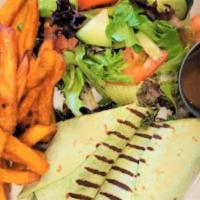 Kale Panini Wrap · Kale, red onions, sun tomatoes, vegan cheddar cheese, sliced avocado, Marley sauce, served i...