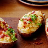 Bacon Loaded Twice Baked Potato · Giant Potato hand scooped and mashed with bacon, red onion, cheddar cheese then topped with ...