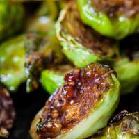 Bacon Roasted Brussels Sprouts · Crispy Fried Brussel Sprouts tossed in apple cider vinaigrette with bacon and fried onion.