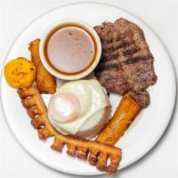 Bandeja Paisa · Grilled steak served with fried eggs, rice, beans and fried sweet plantain.