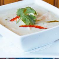 Chicken Coconut Soup · Slices of chicken breast in coconut milk with galanga, lime leaves, mushroom, and lime juice.