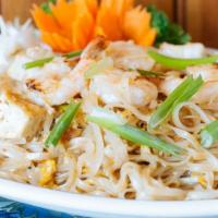 Pad Thai · Stir fried thin rice noodles with shrimp, bean curd, bean sprouts, scallions, egg, ground pe...