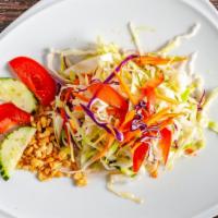 Som Tum · Freshly grated cabbage, carrot tossed with lime juice, tomatoes, ground peanuts, chili, and ...