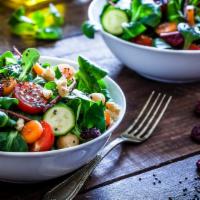 Signature Salad · Mesclun mix, romaine, arugula, cucumber, cherry tomatoes, shredded carrot, red grape, red ca...