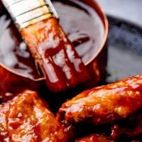 Bbq Jerk Chicken Wings Breaded Fried · 6 fried breaded bone in pieces glazed and drizzled with our house special jerk BBQ sauce.