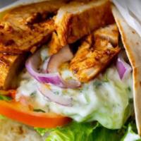 Grilled Jerk Chicken Wrap · Made fresh with jerk chicken, lettuce, tomatoes, shaved carrots, shredded Monterey Jack Ched...