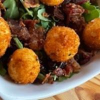Fried Goat Cheese Salad* · arugula, bacon, candied pecans, dried cranberry with brown butter vinaigrette