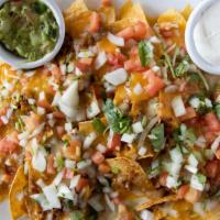 Nachos Supreme · Choice of ground sirloin, barbacoa,
chorizo or shredded chicken. Served with refried beans, ...