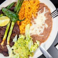 Carne Asada · Charbroiled skirt steak served with rice, beans and guacamole. Garnished with grilled green ...